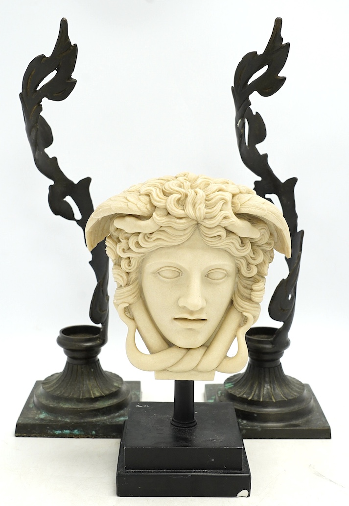 A decorative resin bust of Medusa and a pair of brass candle stands, 40cm. Condition - fair